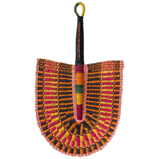 Other side of handwoven Ghanaian Bolga fan in orange, pink and black raffia with a leather-wrapped handle, shield-shaped weave, against a white background, facing downwards from handle