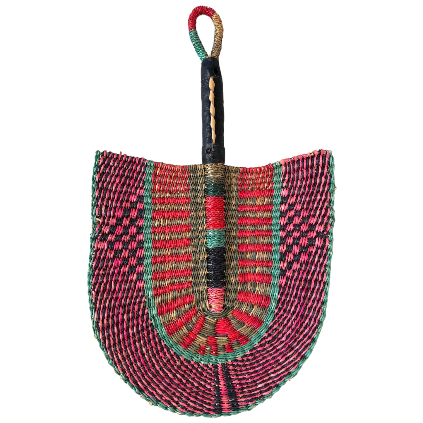 Other side of handwoven Ghanaian Bolga fan in pink, green and black raffia with a leather-wrapped handle, shield-shaped weave, against a white background, facing downwards from handle