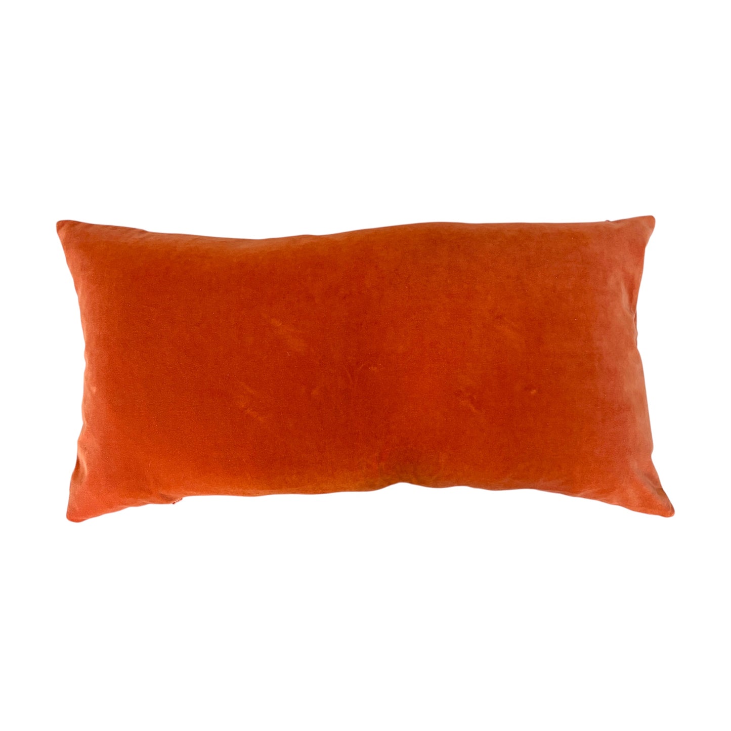 the back of a Swat Valley Wedding Cushion in a vibrant burnt orange velvet fabric.