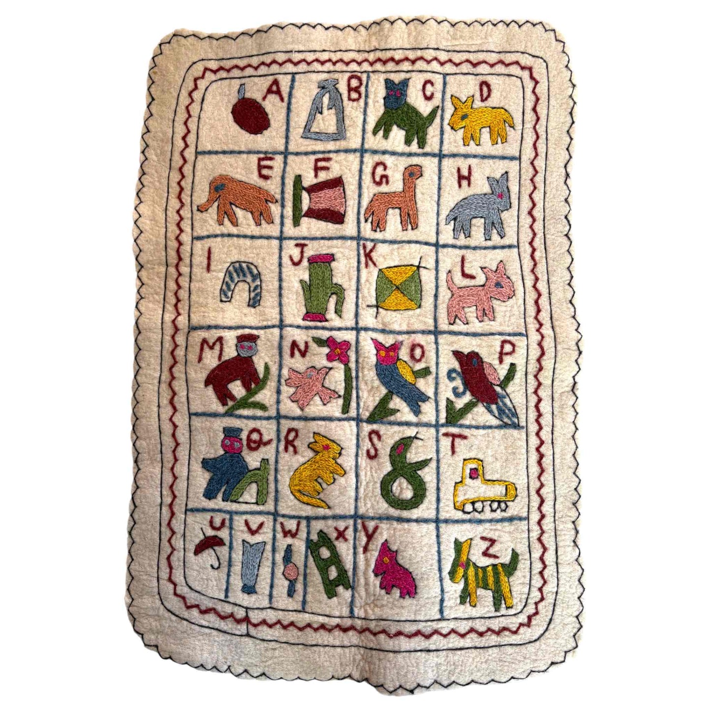 Alphabet wall hanging, showing a Namda technique. Cream wool with colourful embroidery on a white background.