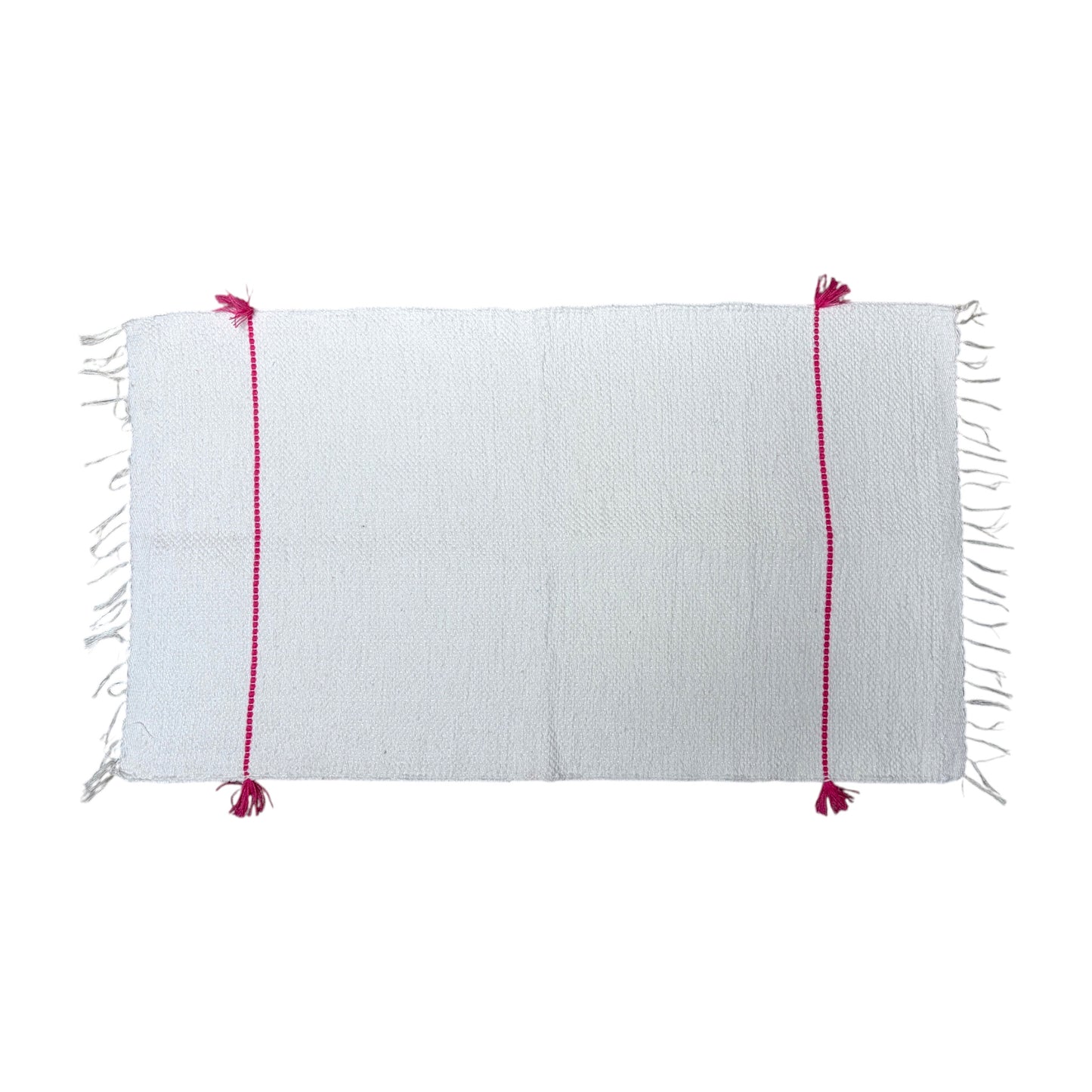 A white woven bath mat with fringe on the short ends and two vertical magenta-pink stitched stripes with tassels, shown flat against a white background.
