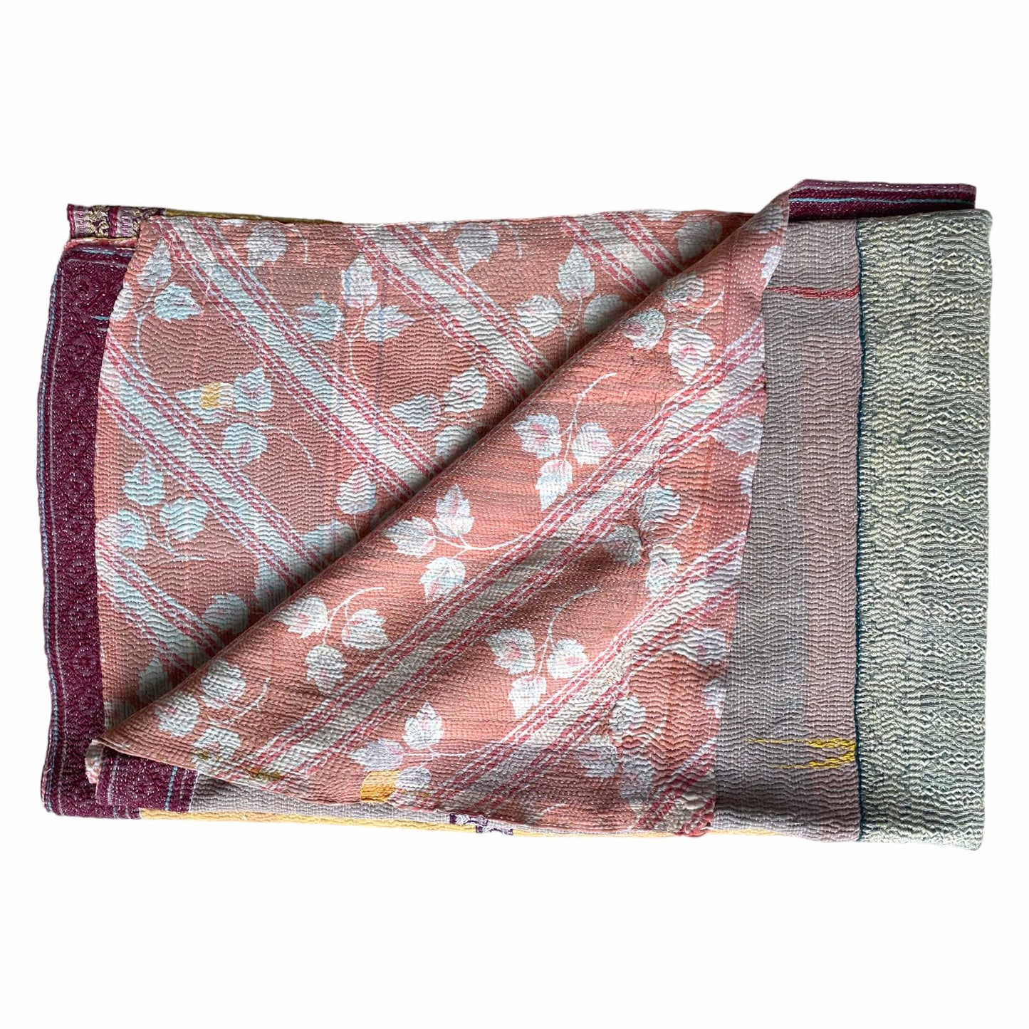 pink and white kantha quilt folded
