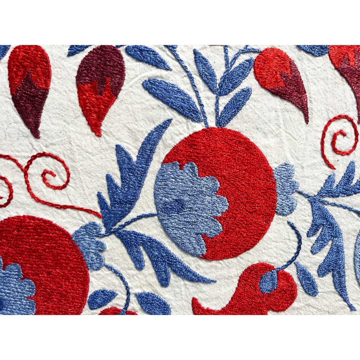 Close up of Plum red and blue Suzani