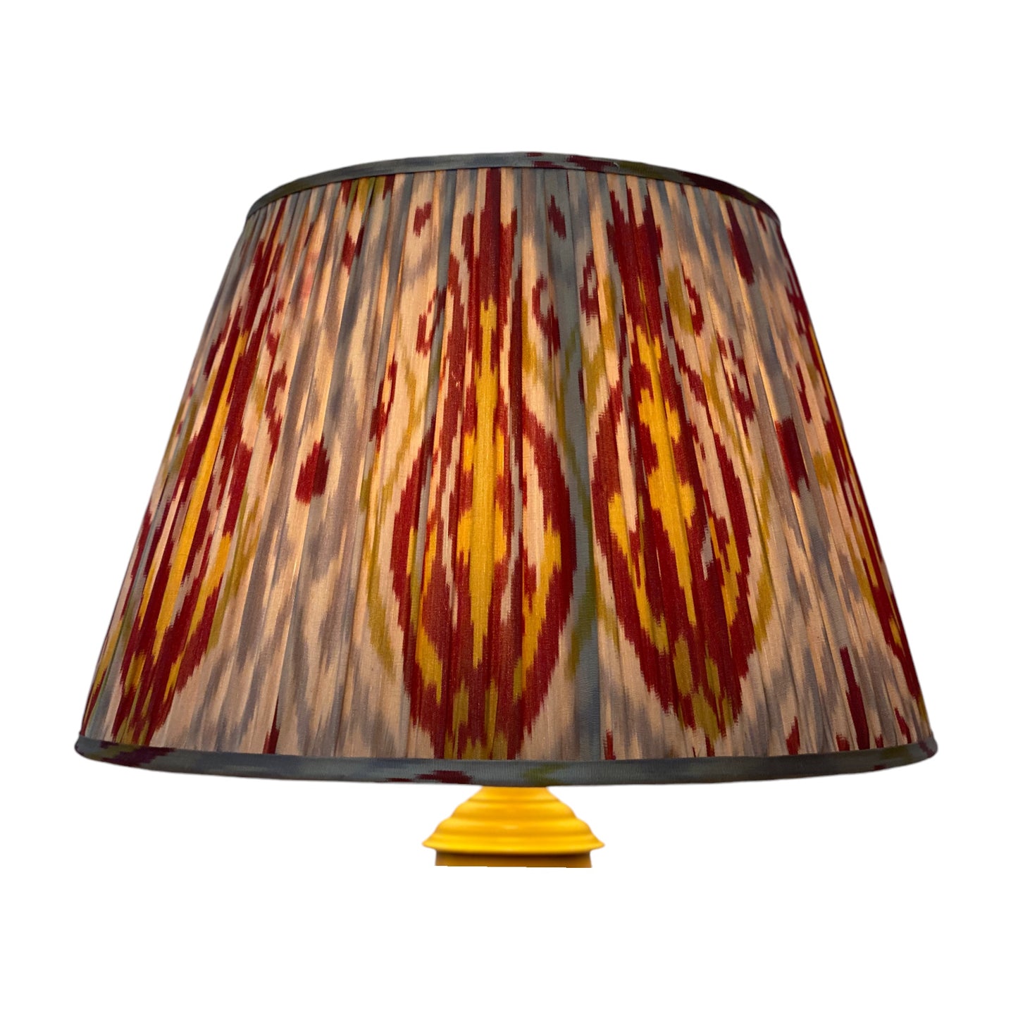 Red and yellow ikat lampshade lit