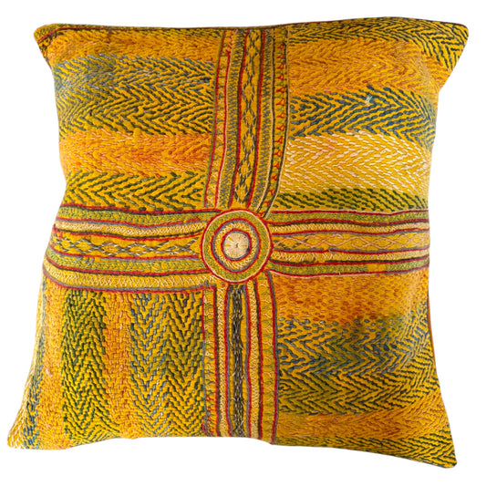 Front view of Banjara yellow embroidered cushion with central circular medallion and cross-stripe geometric pattern in green, red, blue, and cream.