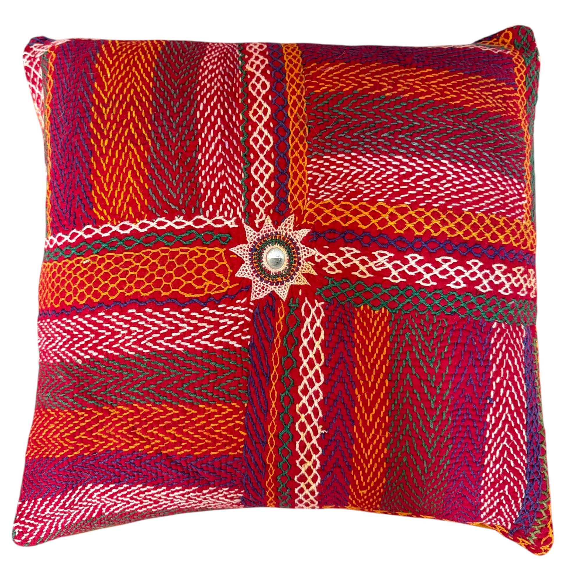 Front view of Banjara multicolour embroidered cushion with central mirror-work star medallion, chevron stripes, and diamond patterns in red, orange, green, and cream.