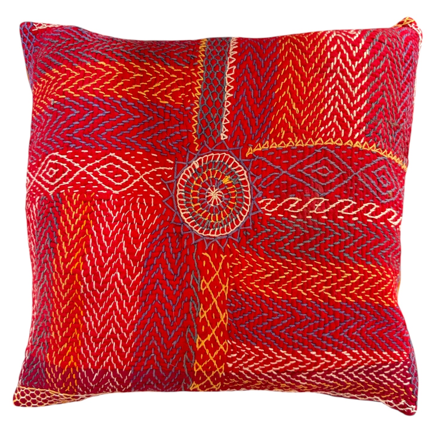 Front view of a square red Banjara embroidered cushion with hand-stitched chevron, diamond patterns, and a central rosette pattern, in blue, gold, and cream thread.