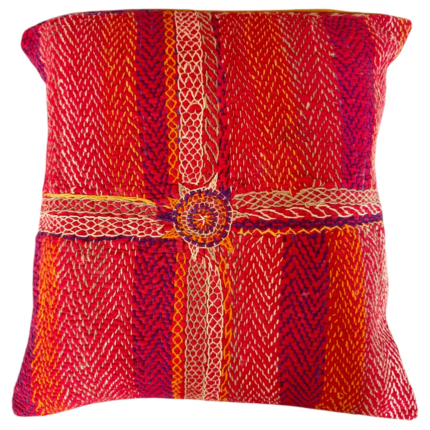 Front view of a square decorative Banjara cushion featuring vibrant red, orange and purple handwoven fabric with a central vertical and horizontal striped pattern and a circular embroidered medallion at the intersection.