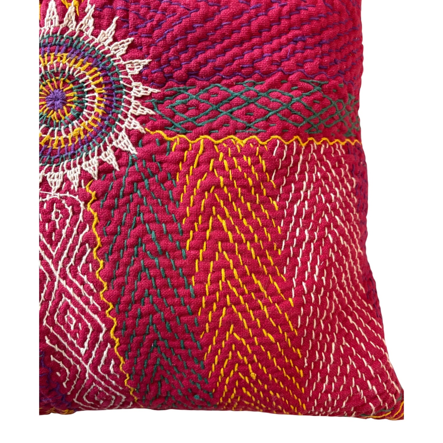 Close up of raspberry red banjara cushion