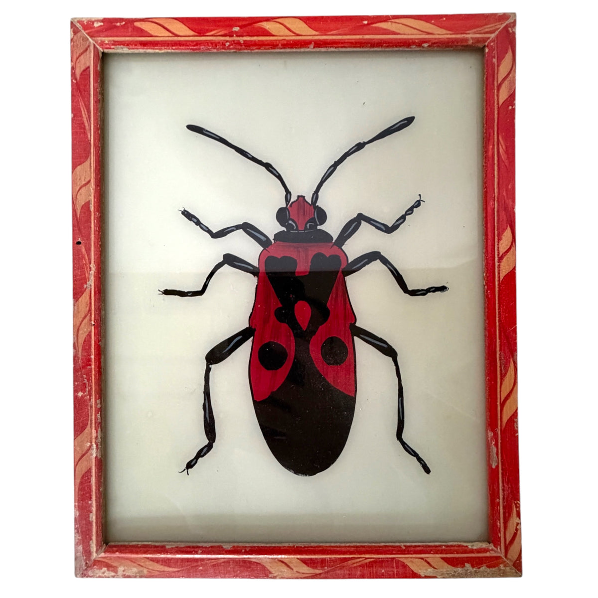 A framed insect art piece featuring a red and black bug illustration on a white background, enclosed in a distressed red frame with gold decorative patterns.