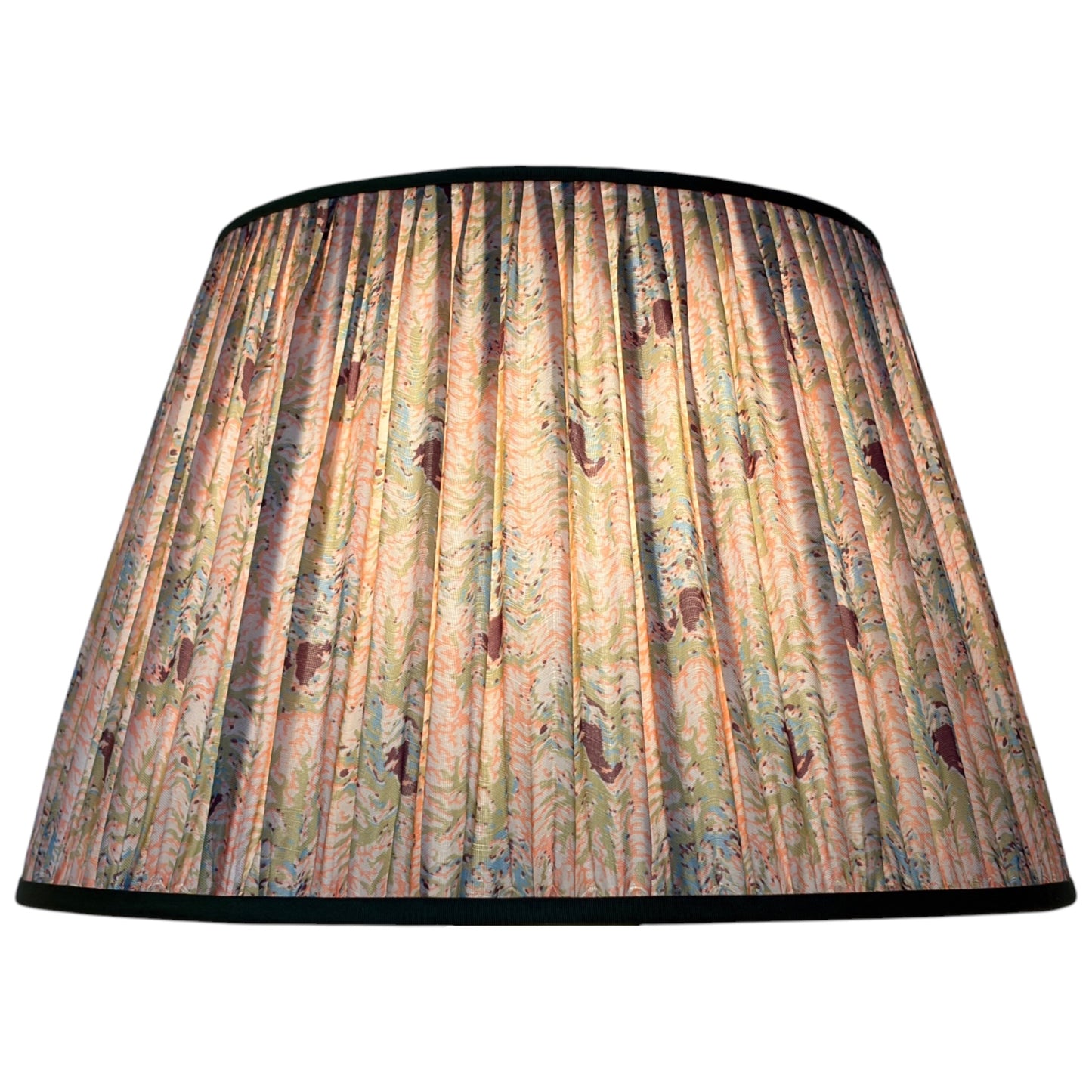 A gathered silk lampshade featuring a vintage coral and seaweed botanical pattern with green leaves, peach and pink flowers finished with olive green trim at the top and bottom with the light on. 