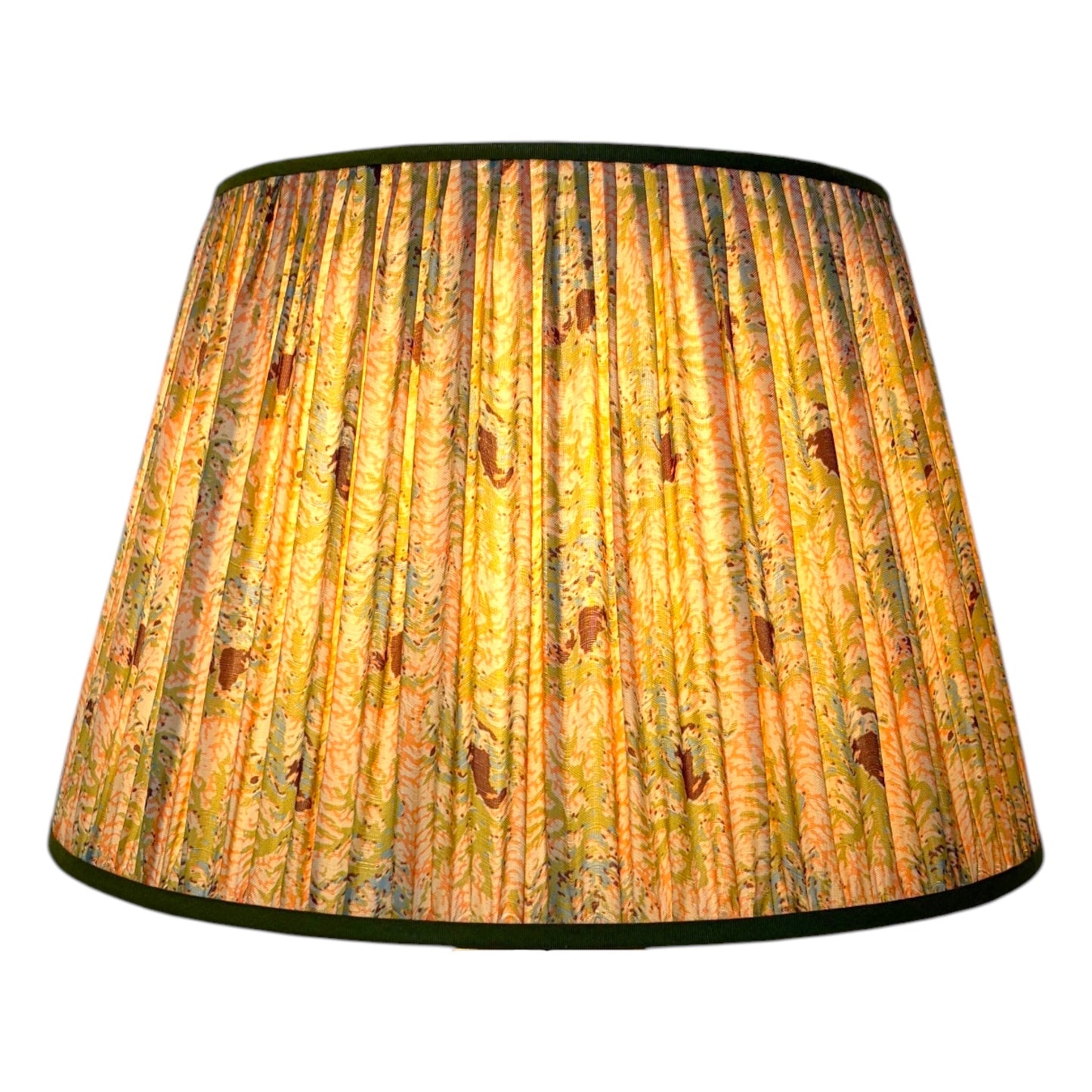 Coral and seaweed silk lampshade glowing from within, showing pleated texture and pattern