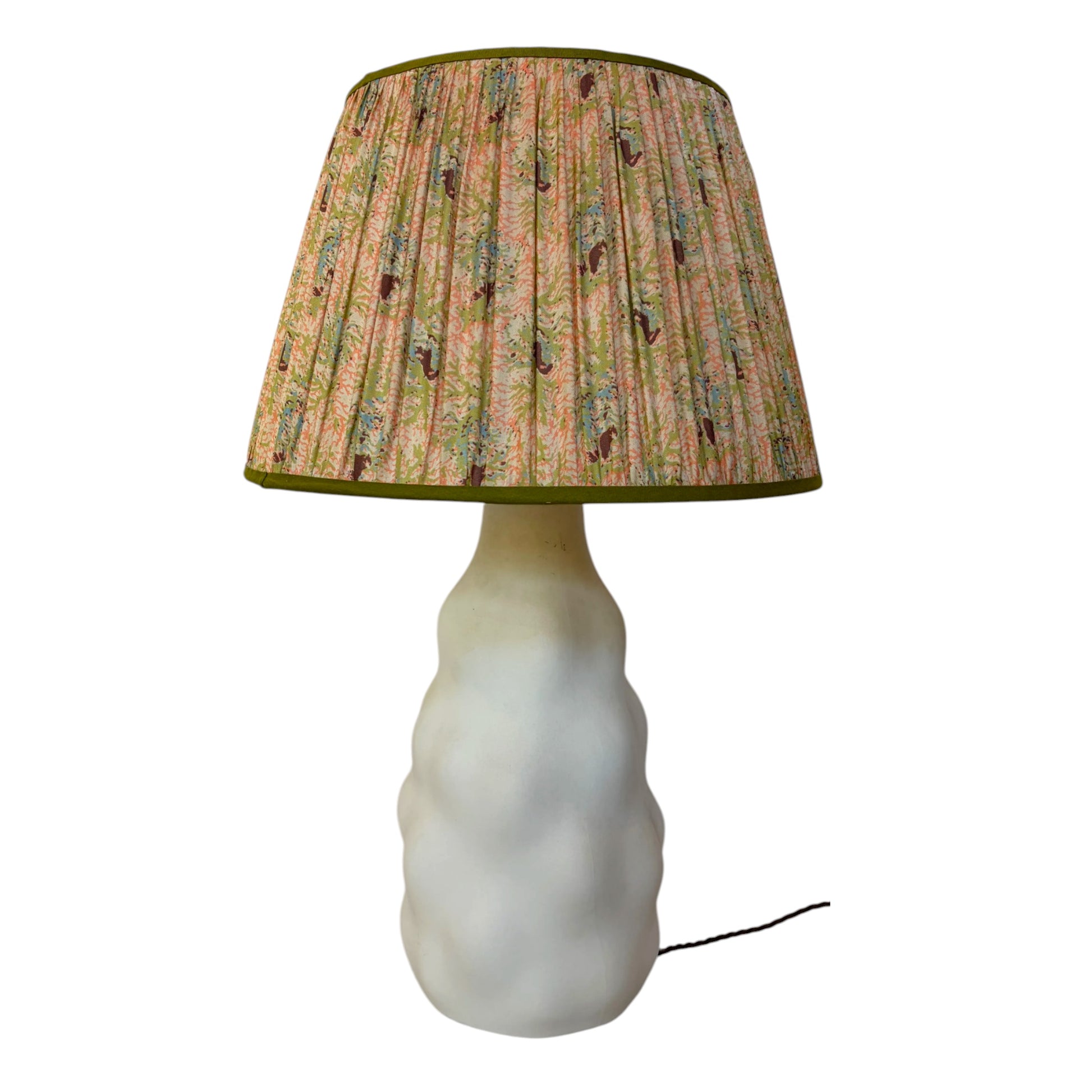 Coral and seaweed print silk lampshade with olive trim on cream ceramic table lamp base.