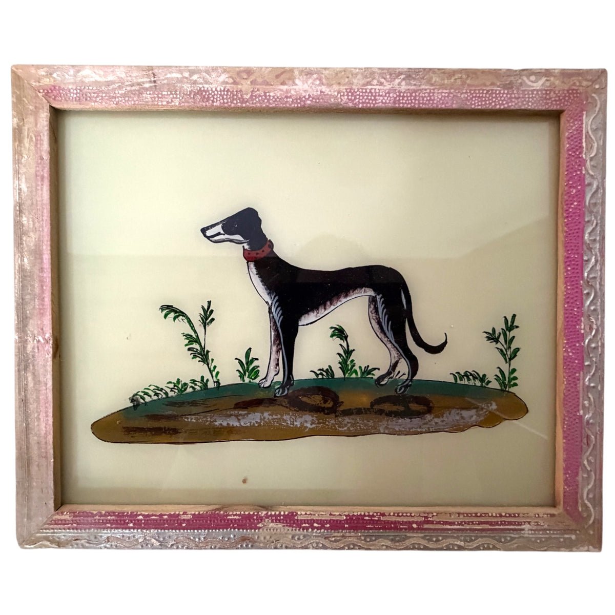 A vintage hand-painted glass panel featuring a black and white greyhound standing on a patch of grass, set within an ornate pink and gold frame.