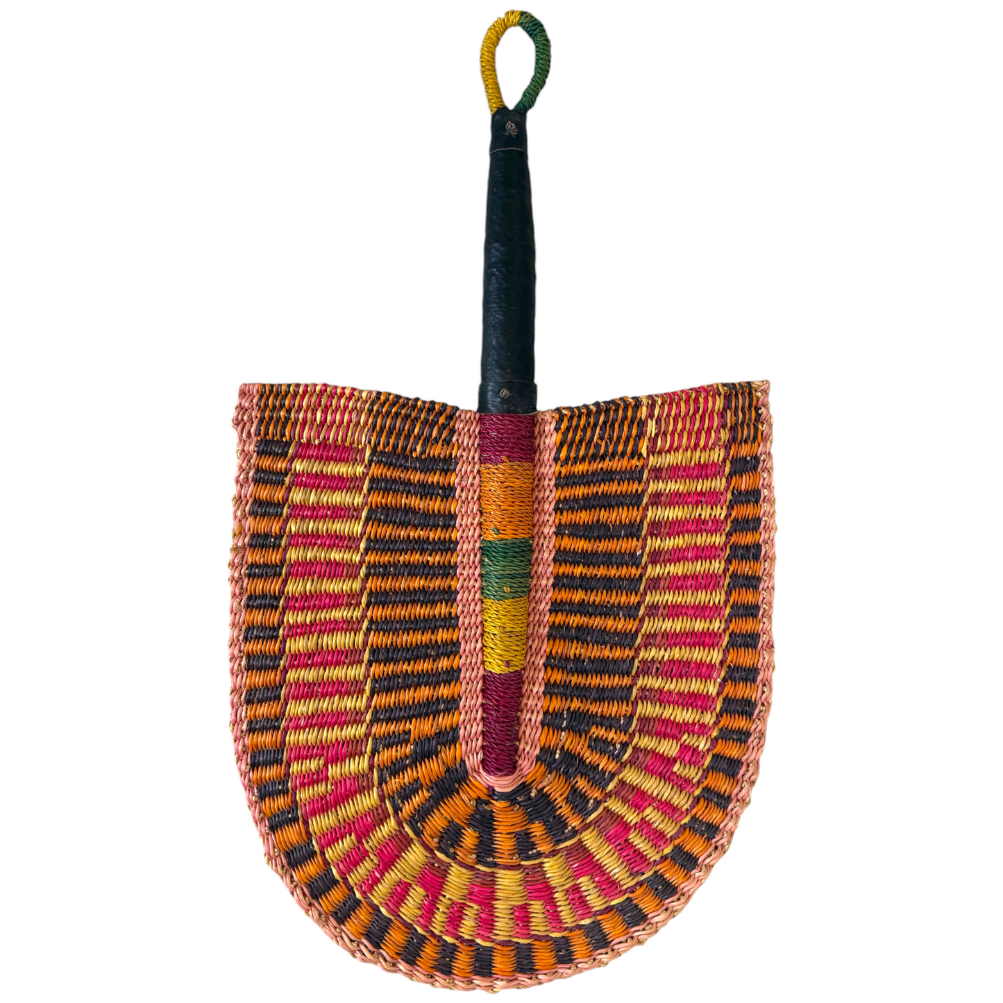 One side of handwoven Ghanaian Bolga fan in orange, pink and black raffia with a leather-wrapped handle, shield-shaped weave, against a white background, facing downwards from handle