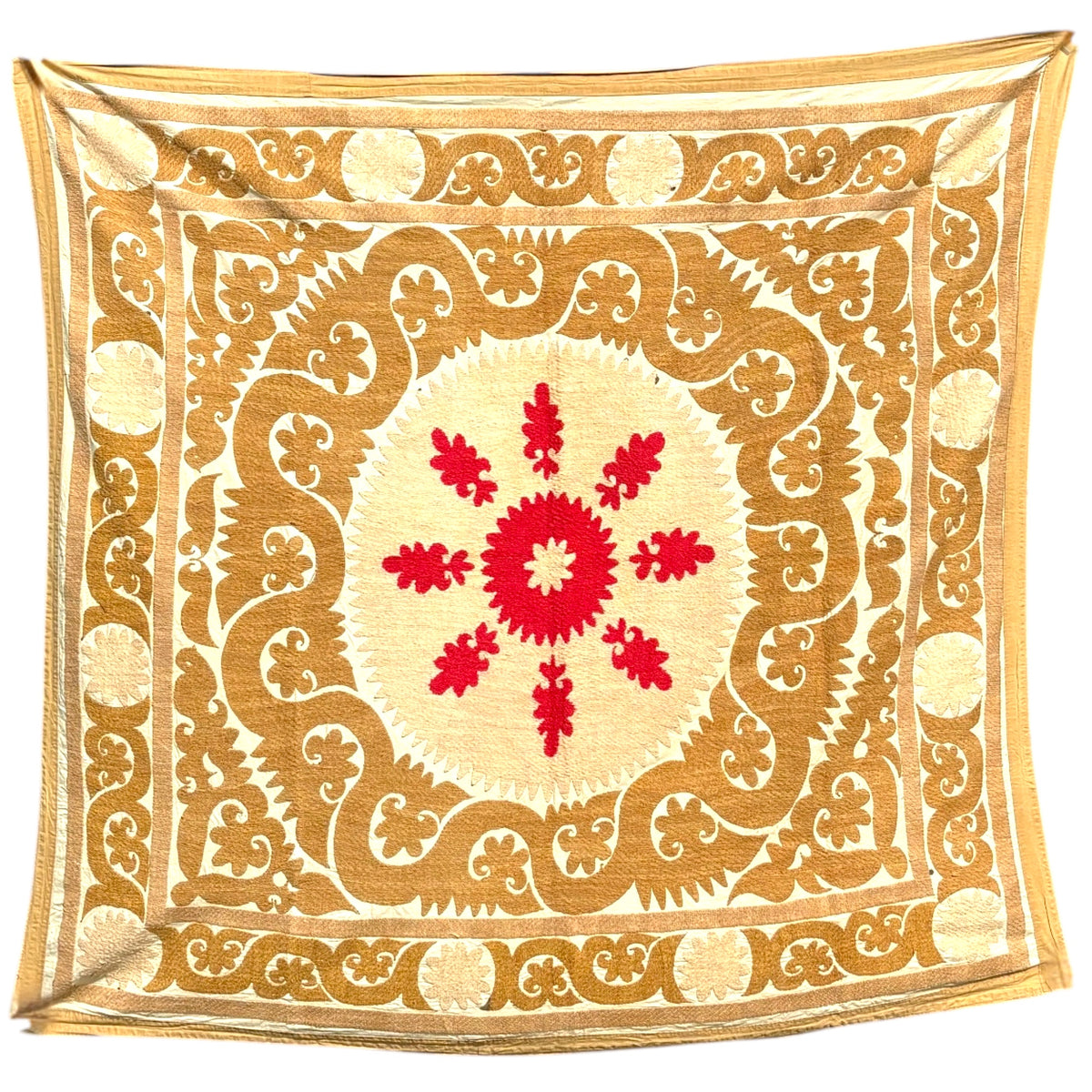 A vintage, square embroidered Suzani from Uzbekistan, featuring a central red floral medallion surrounded by cream and gold ornamental patterns, shown flat against a white background.