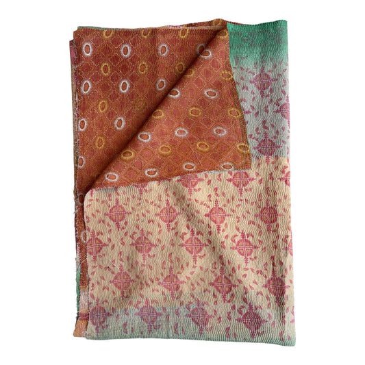 Green and red kantha quilt
