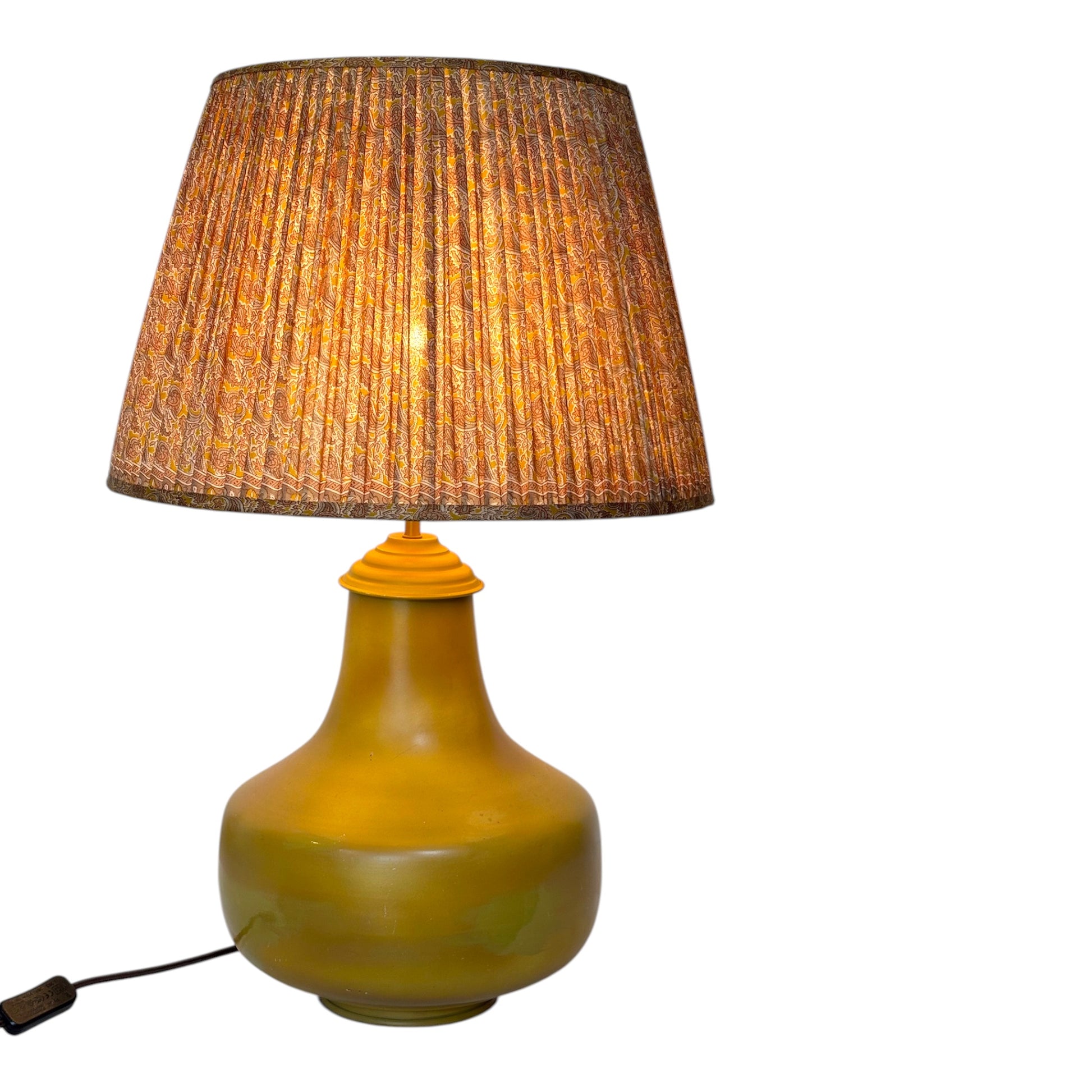 Indian yellow lampshade lit 
