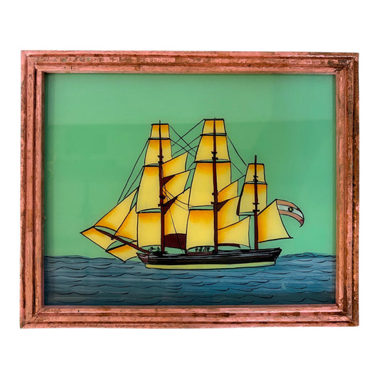 glass painting of a sailing boat within a wooden frame on a white background