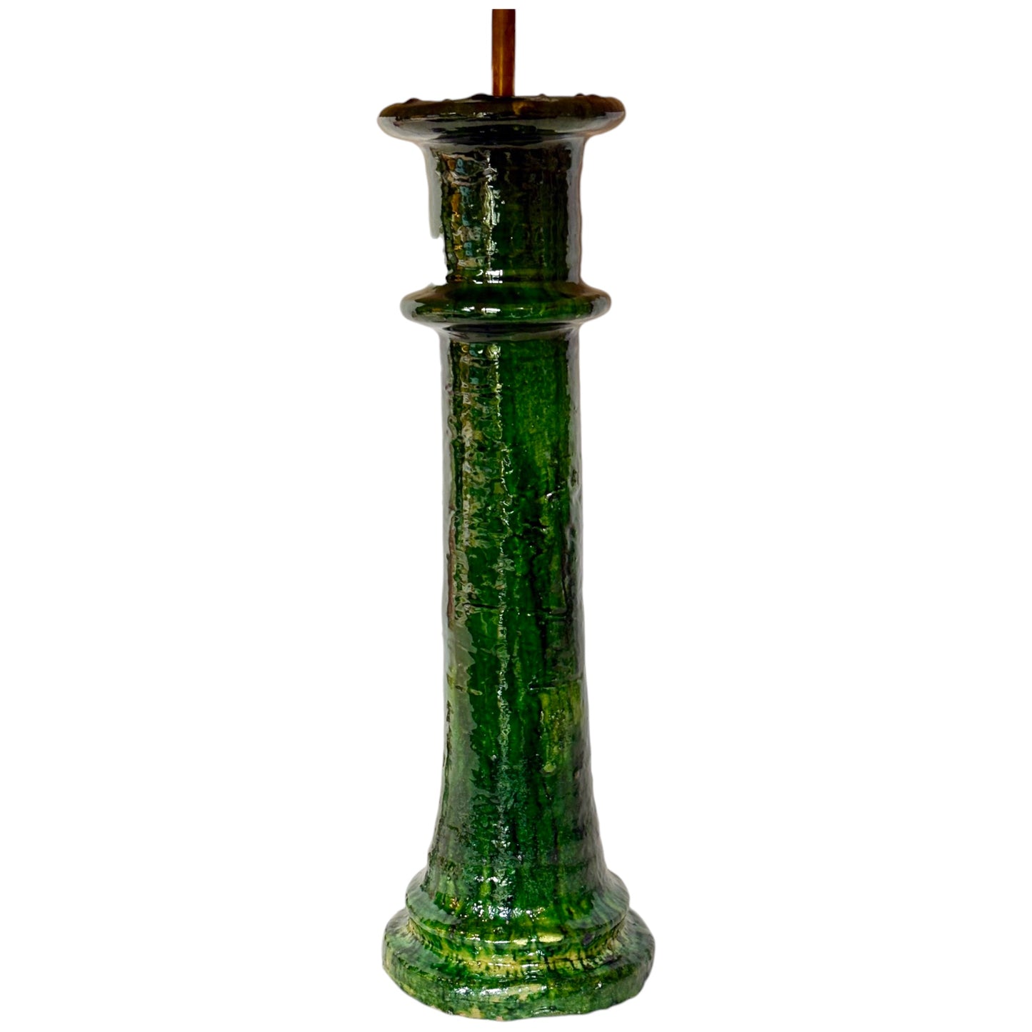 A green ceramic pillar candlestick table lamp with a textured, glossy finish and a brown wick, shown against a plain white background.
