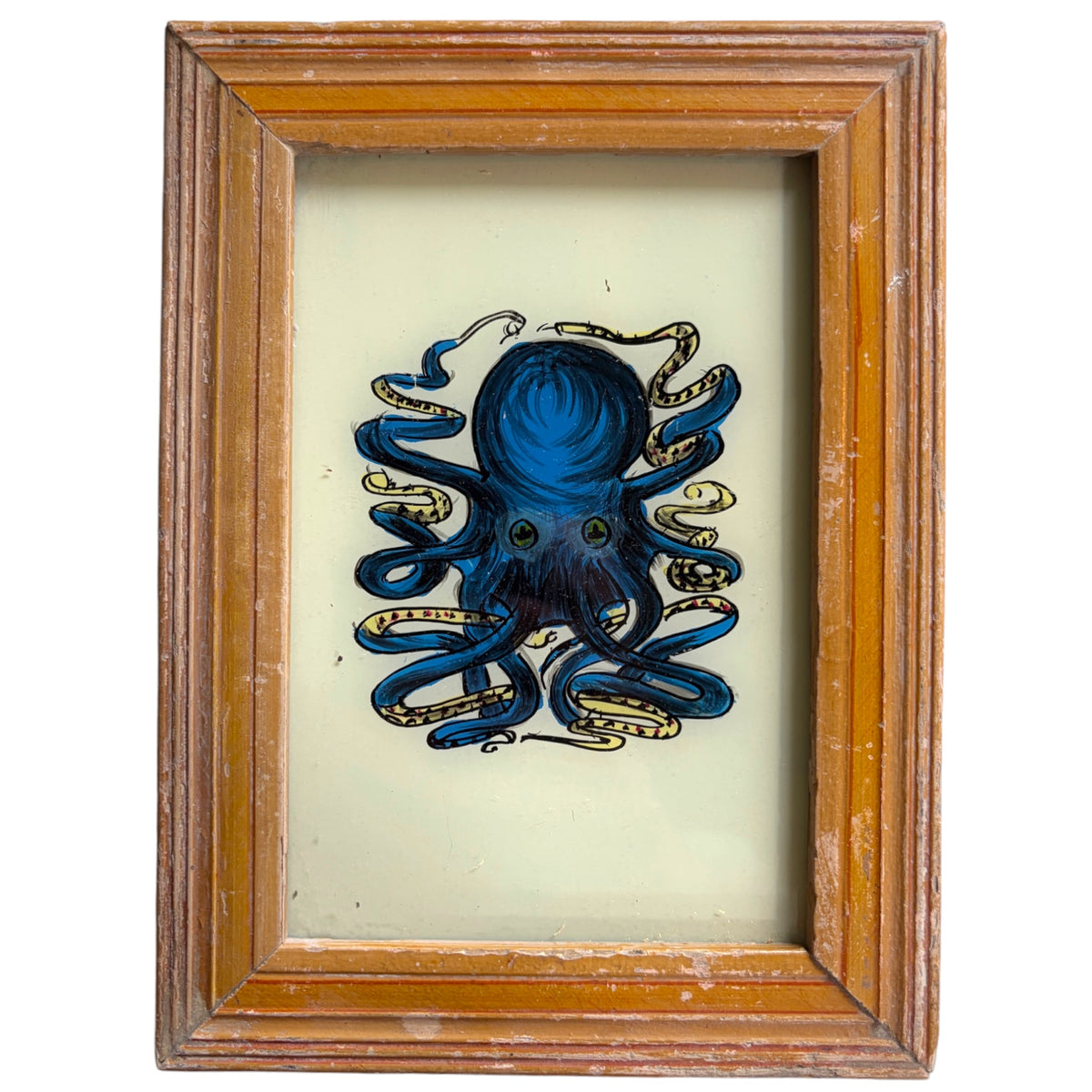 A framed art print featuring a blue octopus illustration with gold accents on a cream background, enclosed in a rustic brown wooden frame.