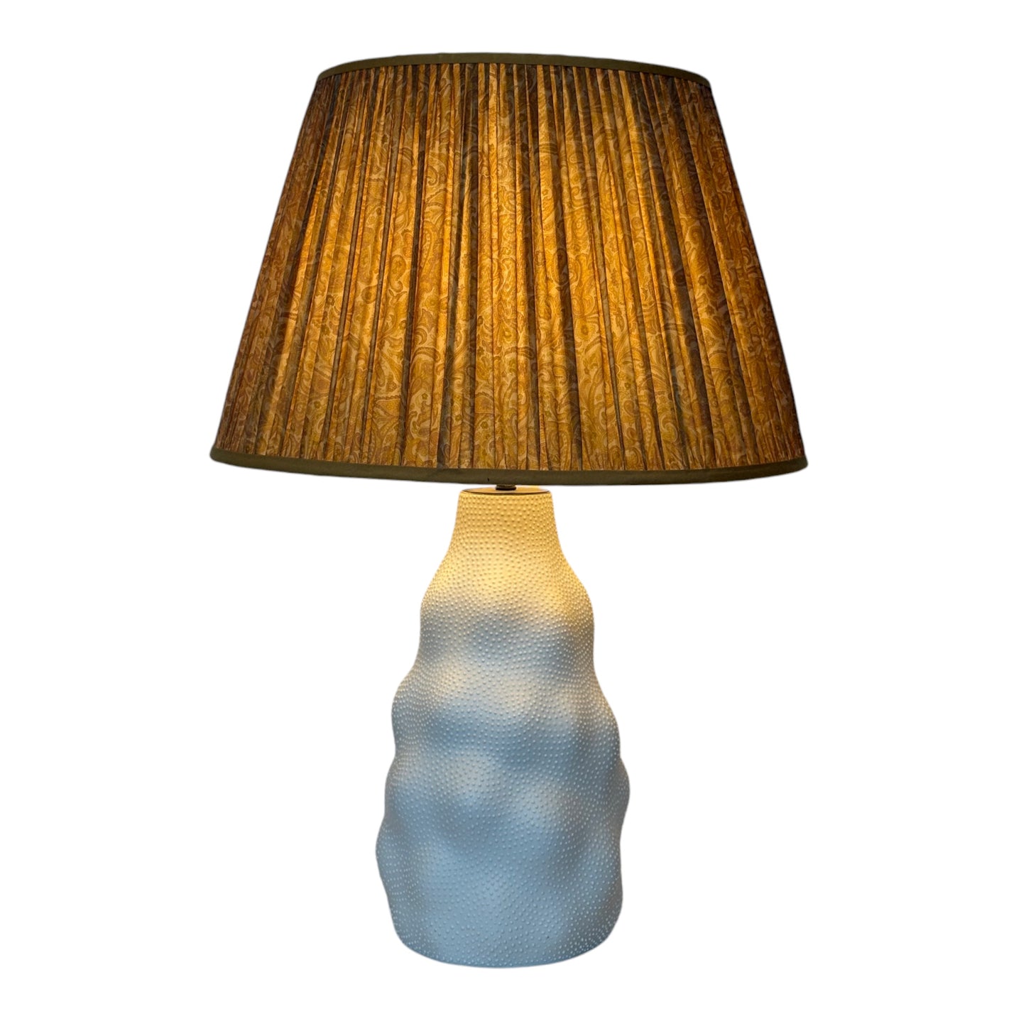 Old gold lampshade lit of Iki lamp