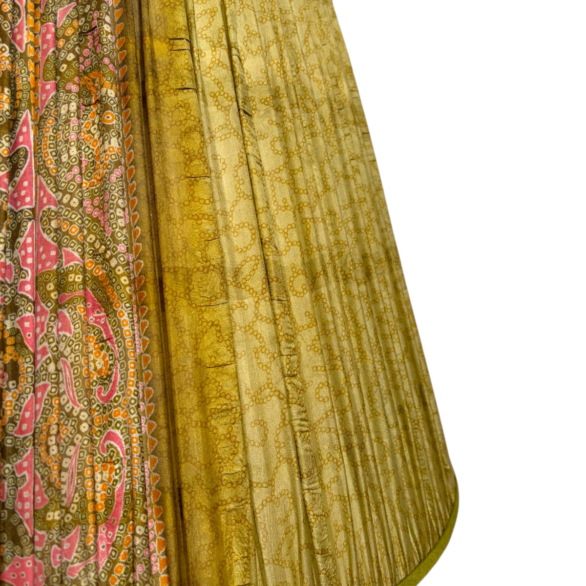 Close-up of gathered olive green vintage silk sari lampshade with a pink and orange paisley pallu panel beside a fine chain-link print