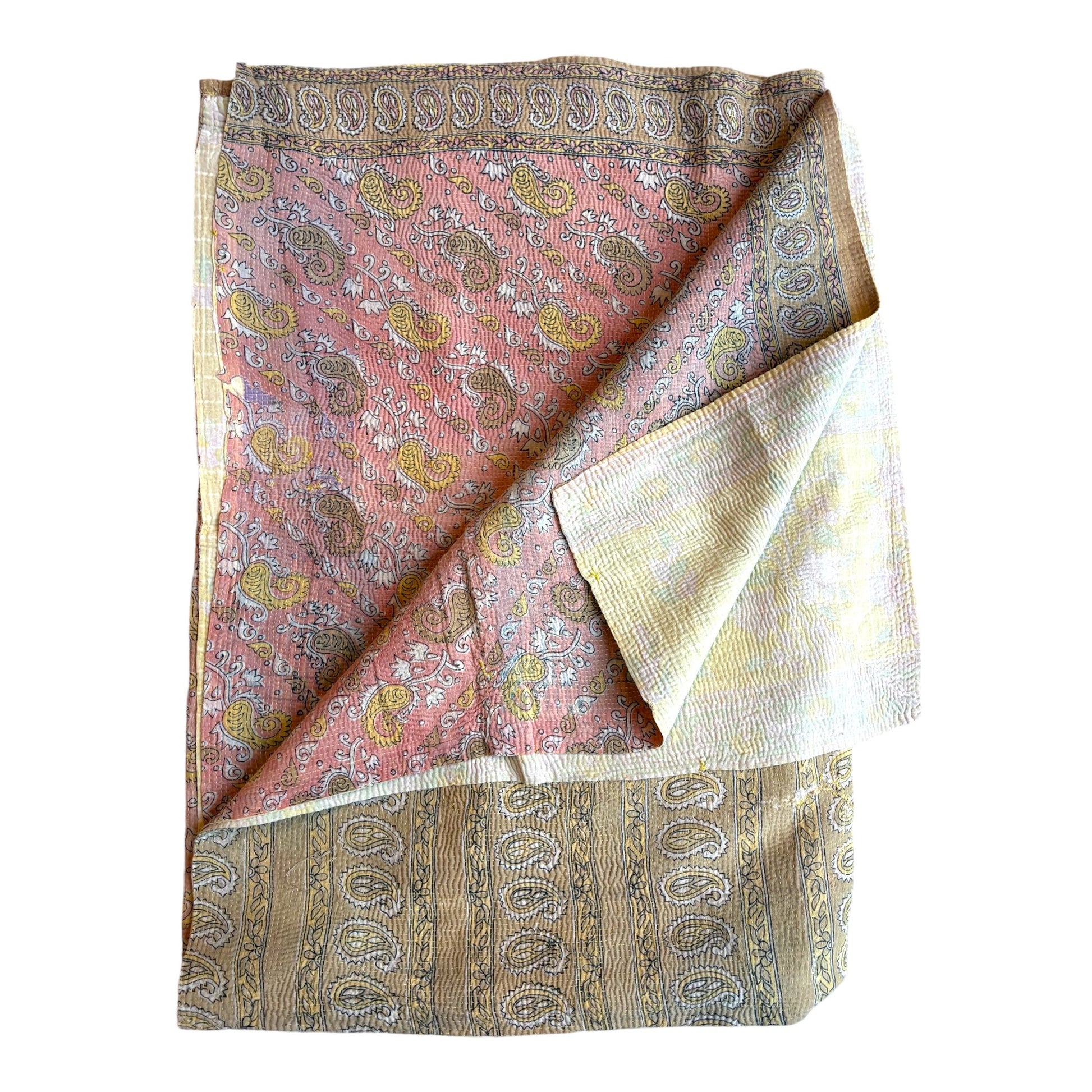 Pale pink and blonde kantha quilt folded