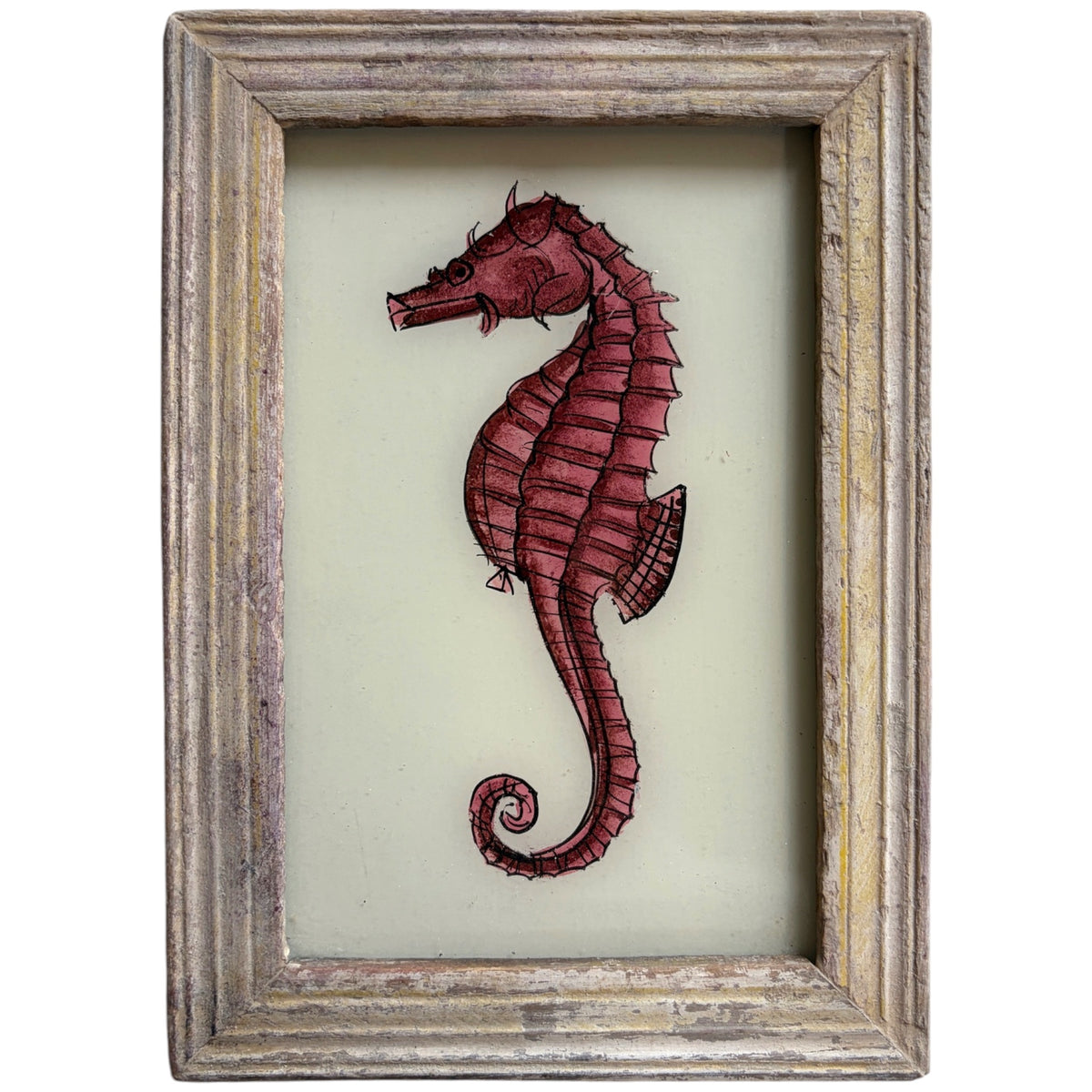 A framed wall art piece featuring a stylized red seahorse illustration on a pale cream background, enclosed in a distressed rustic wood frame.