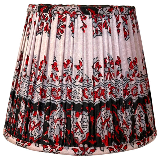 Small 15cm gathered silk sari lampshade with a red, grey and black floral block print on a blush pink ground and a deep black patterned border at the base.