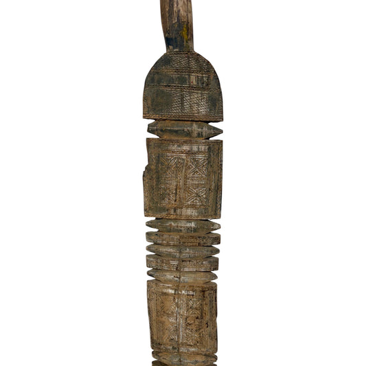 An intricately carved wooden decorative object with geometric patterns and a weathered, rustic finish, isolated on a white background.