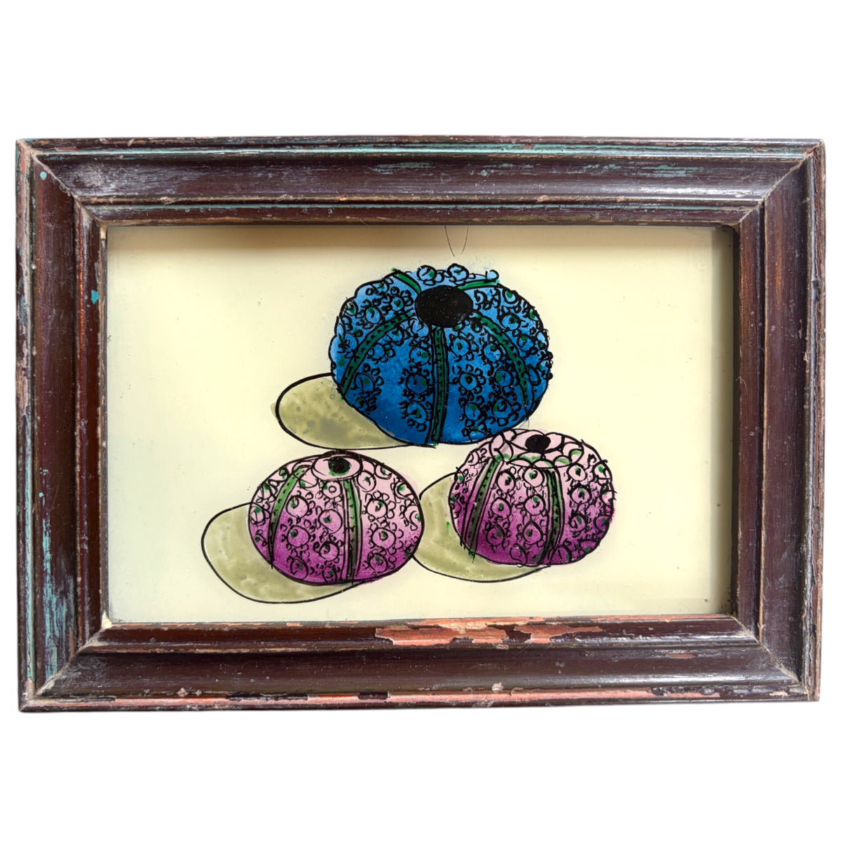 A framed art print featuring three sea urchins in a triangular arrangement. The top sea urchin is blue, and the two bottom sea urchins are purple, all with black ornamental patterns.