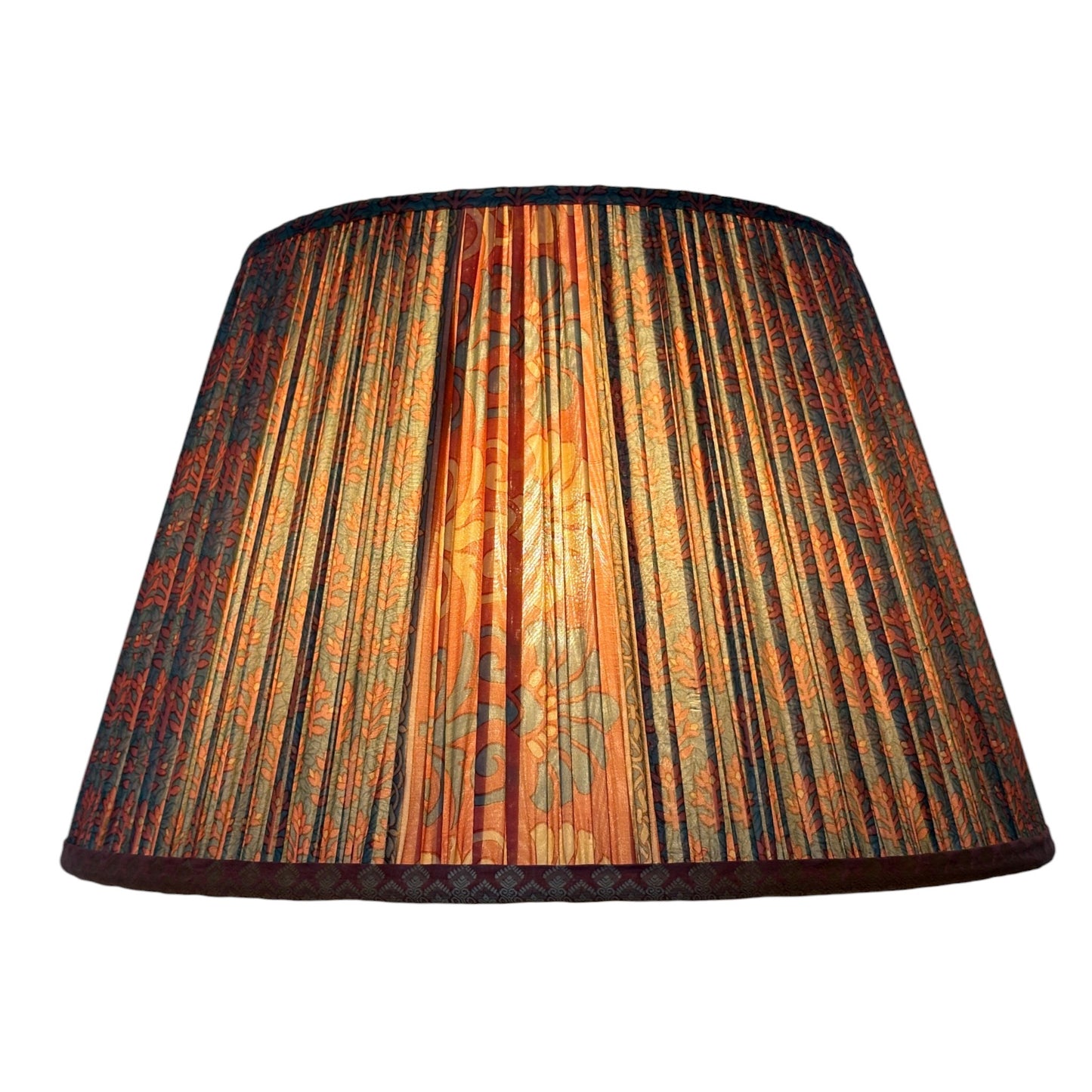 Terracotta and teal lampshade lit