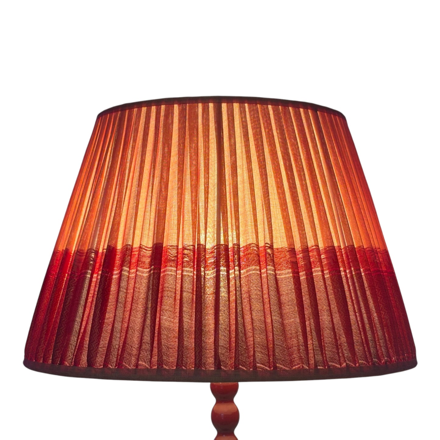 Lit tumeric and red lampshade