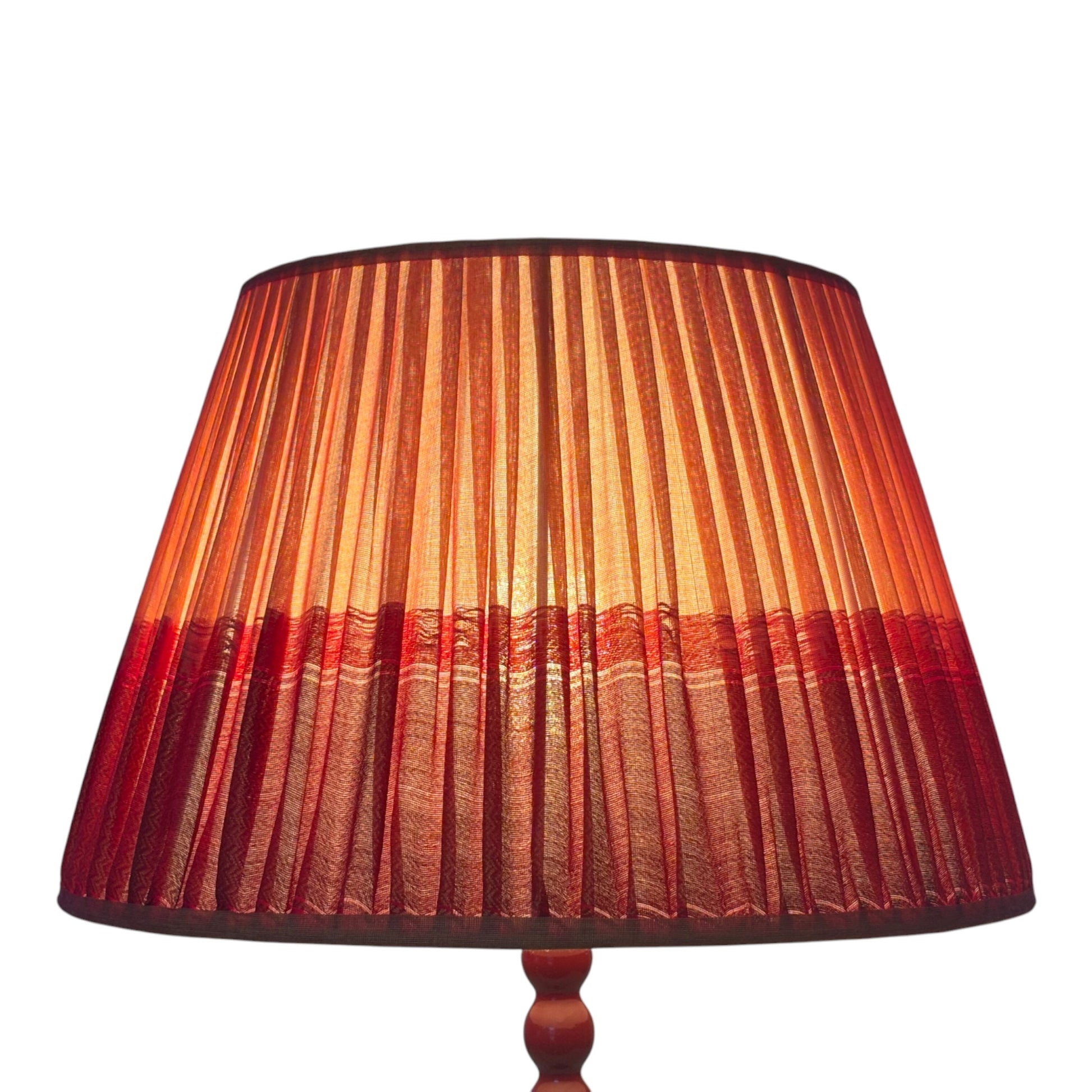 Lit tumeric and red lampshade
