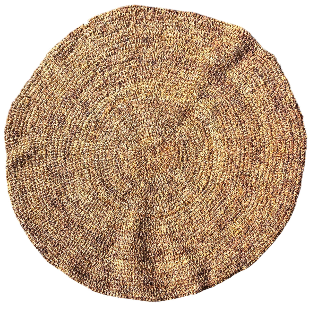 A round, hand-woven natural fiber rug in a textured tan and brown color palette, shown from a top-down perspective on a solid white background.
