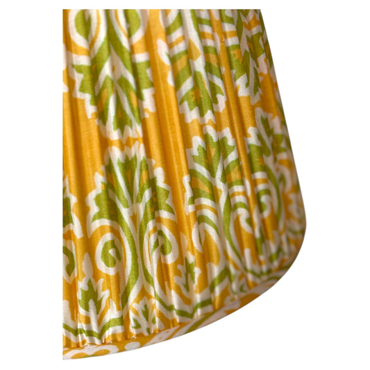 A close-up of the gathered vintage silk sari lampshade with a yellow, green, and white paisley pattern. 