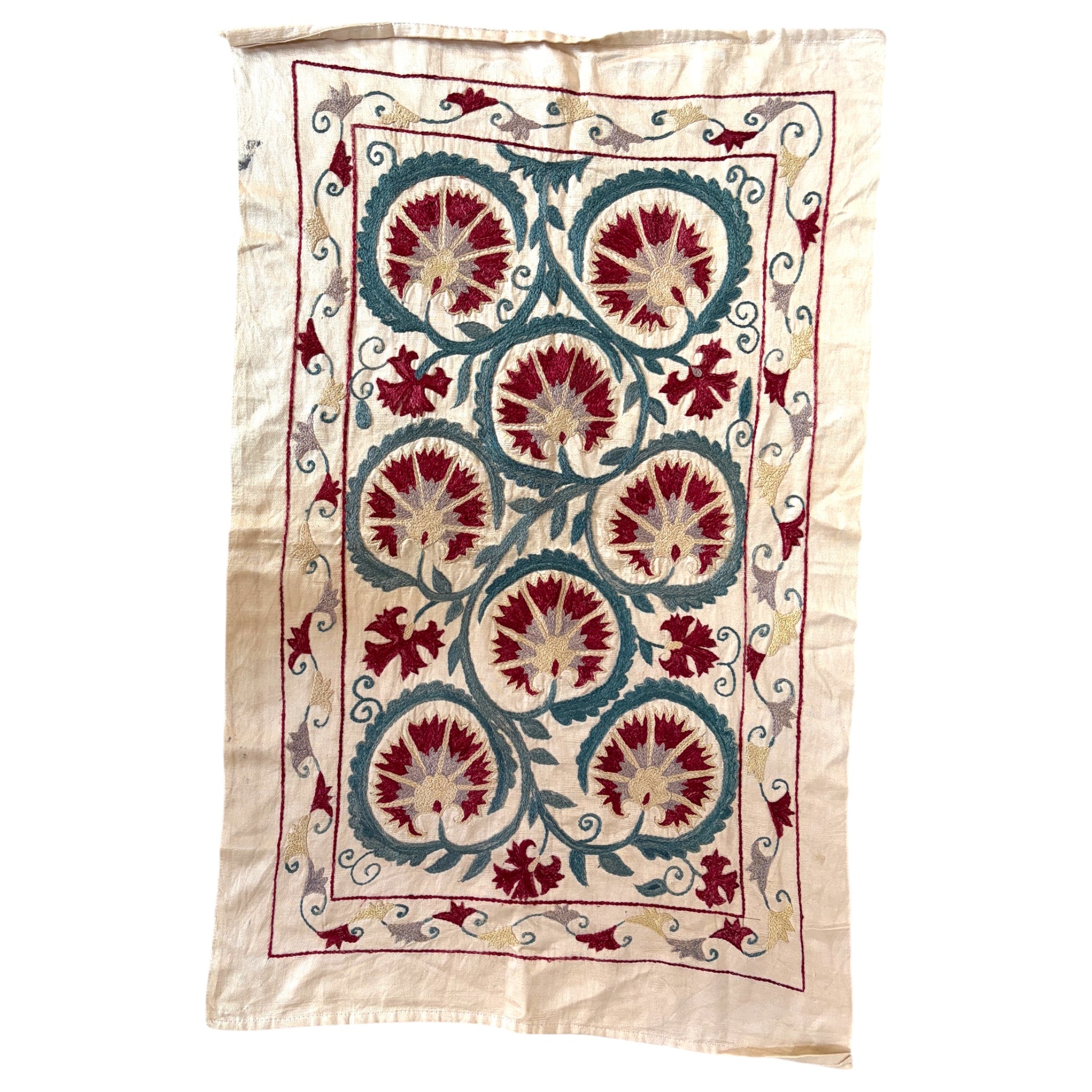 Vintage hand-embroidered silk Suzani textile with seven crimson carnation medallions on cream silk background. 