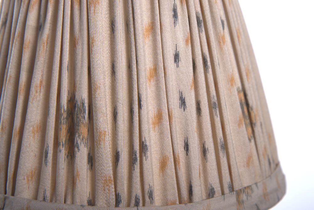 Cream ikat silk lampshade close up with a white background