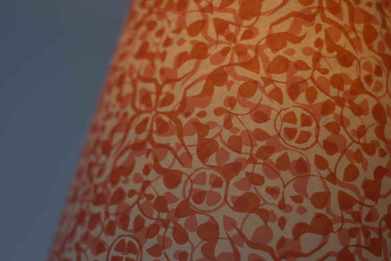 Red paper lampshade lit
