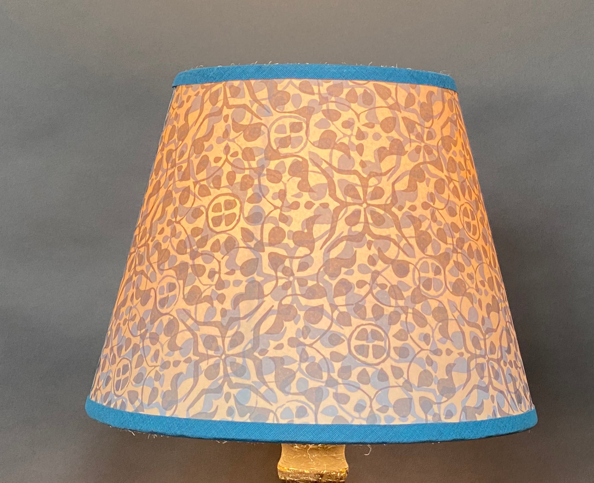 Dappled blue paper lampshade lit