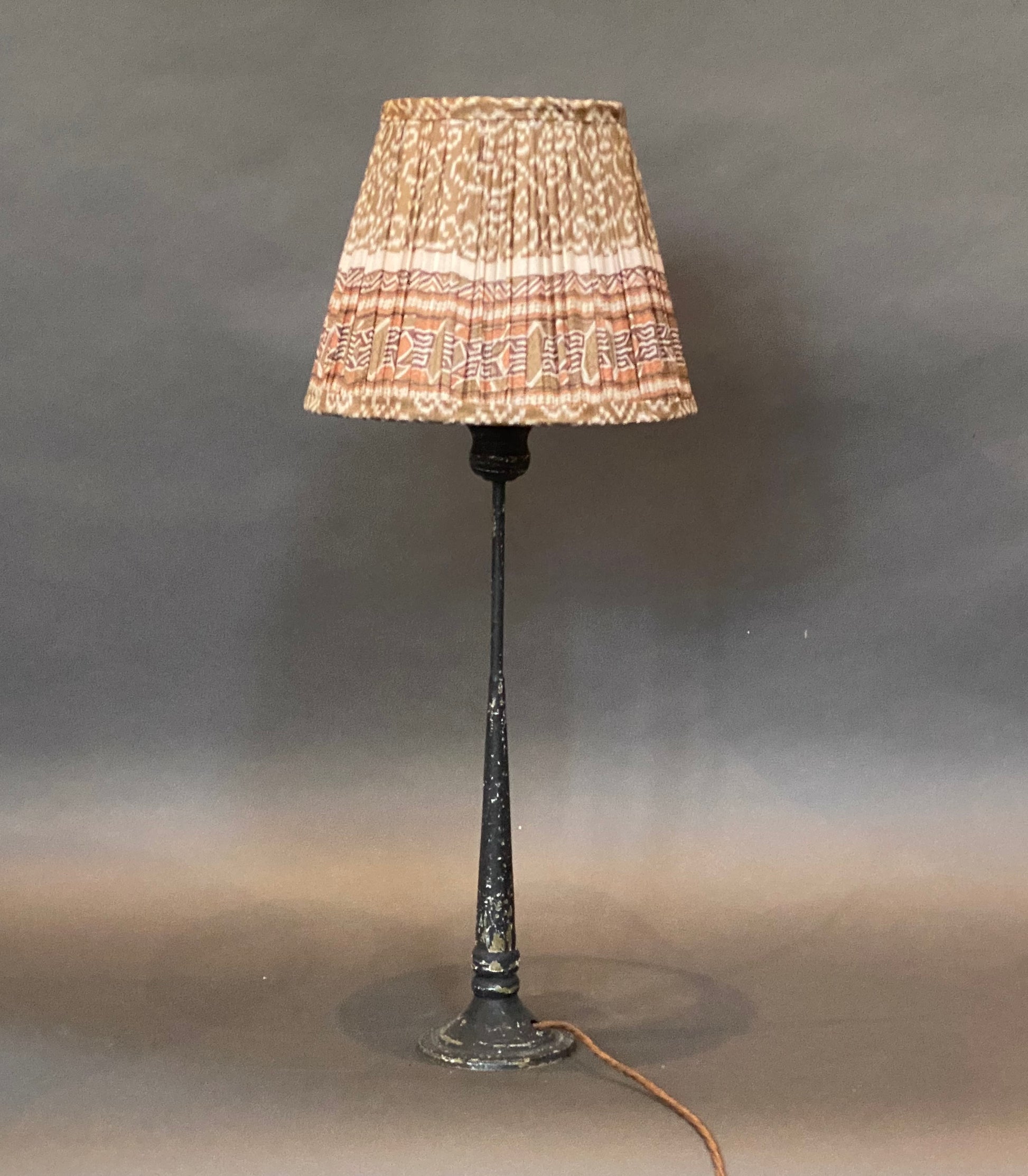 Donkey geometric with border silk lampshade shown on a candlestick lamp base