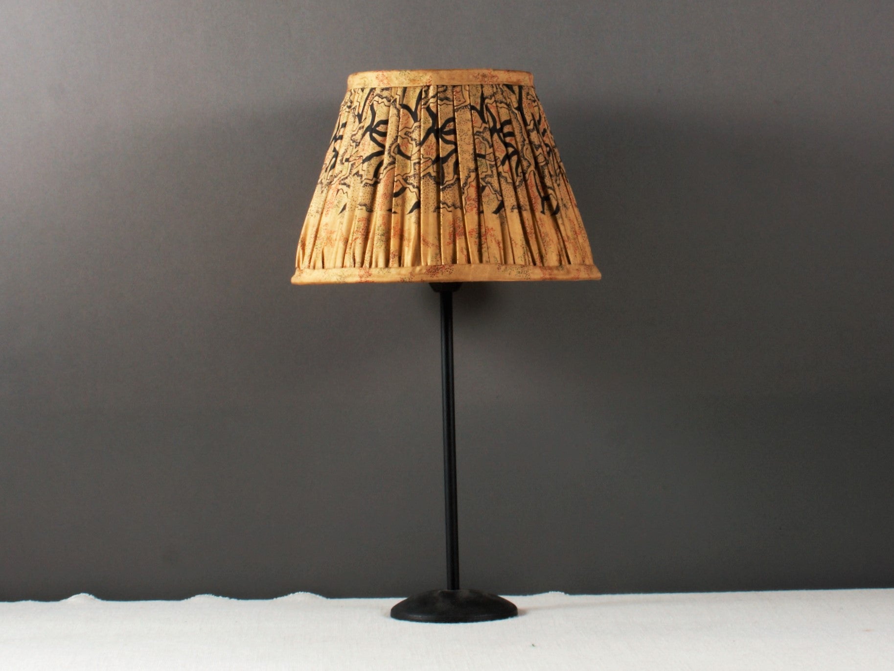 Sand And Black Silk Lampshade on a candlestick lamp base