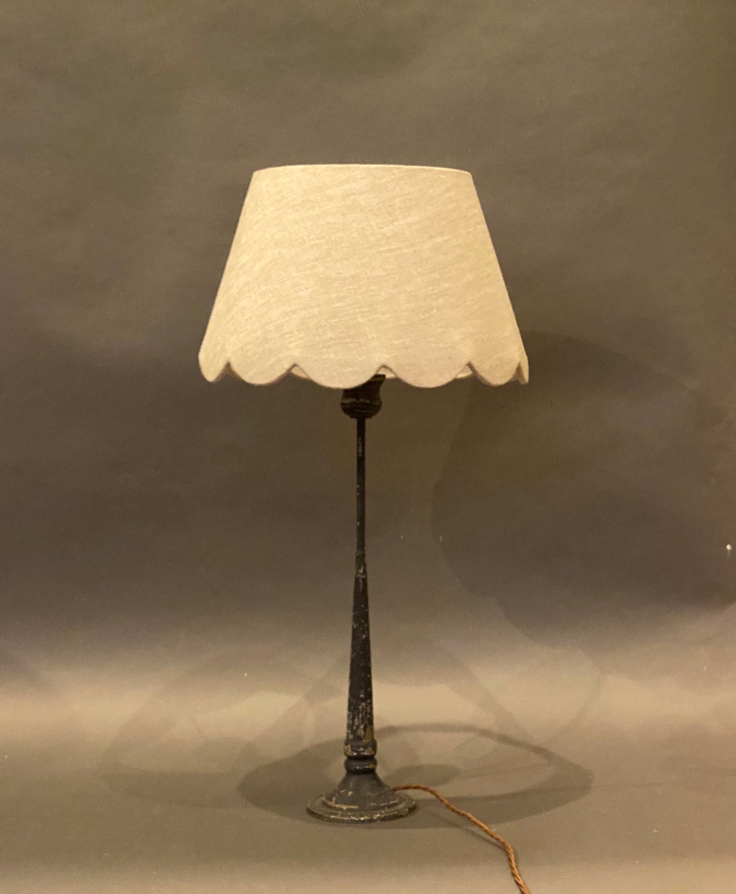 Plain Linen Scallop Lampshade shown on a candlestick lampbase