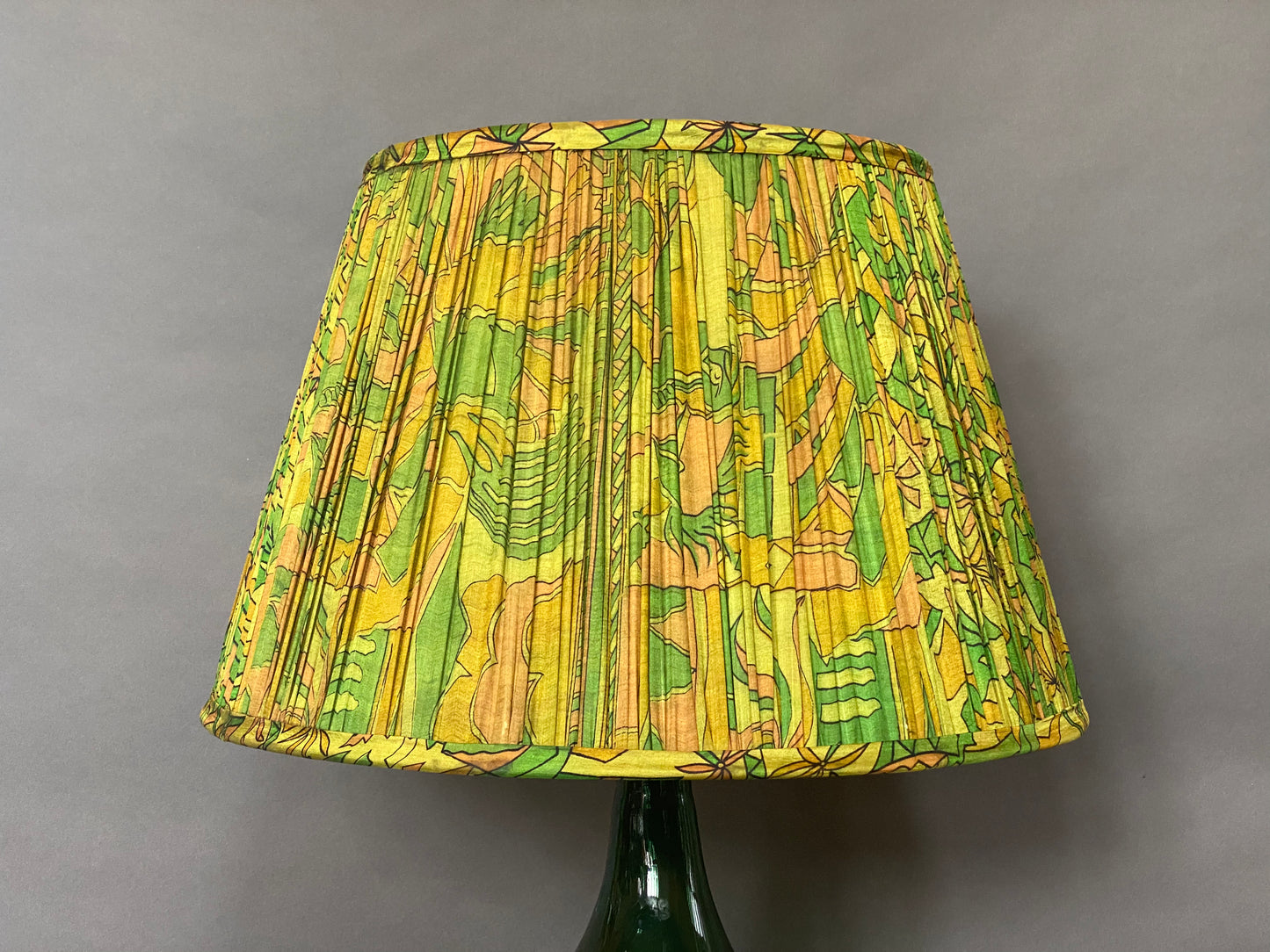 Green & citrine silk lampshade on a grey background