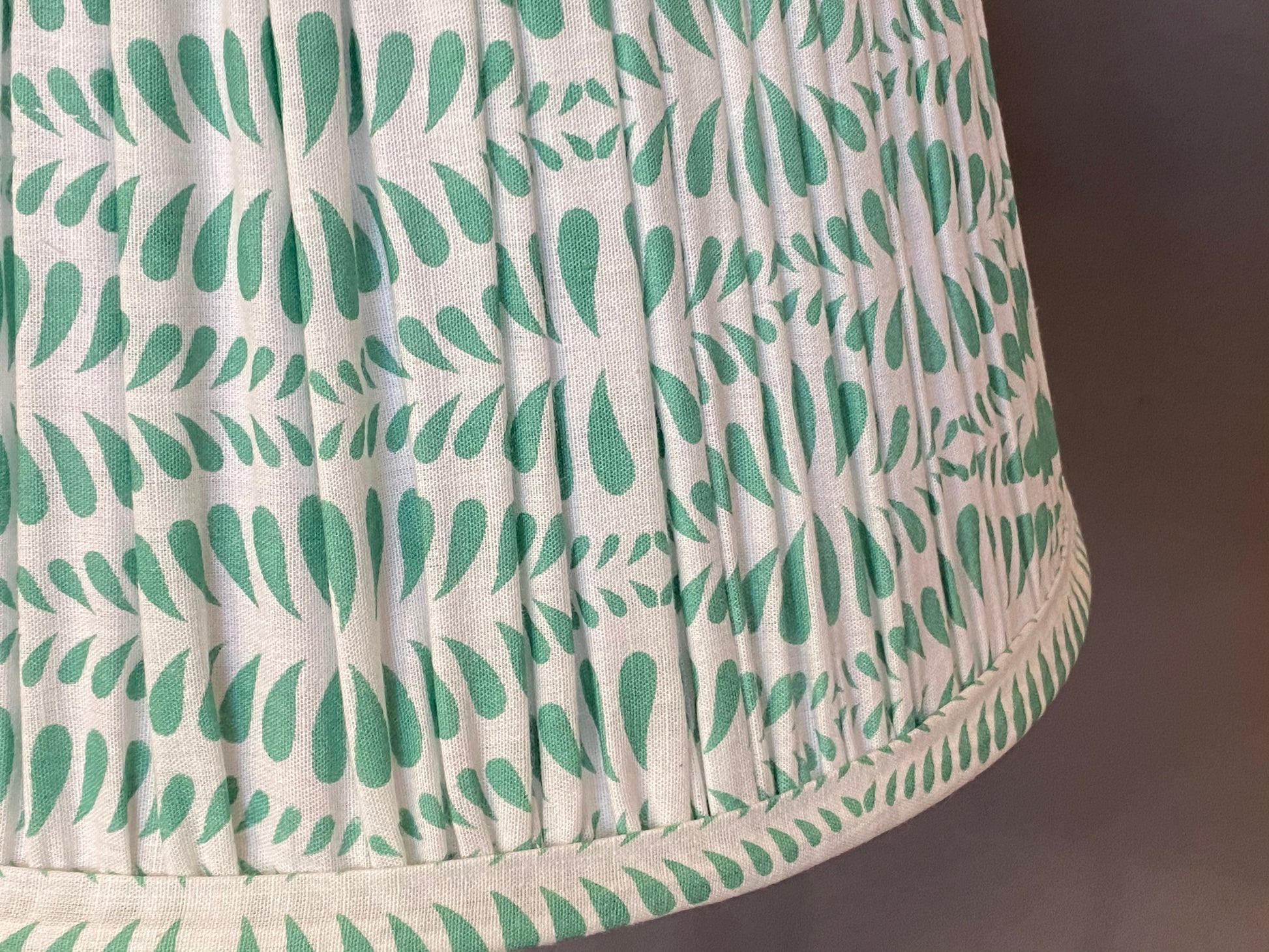 Green Bangla Cotton Lampshade close up on a grey background