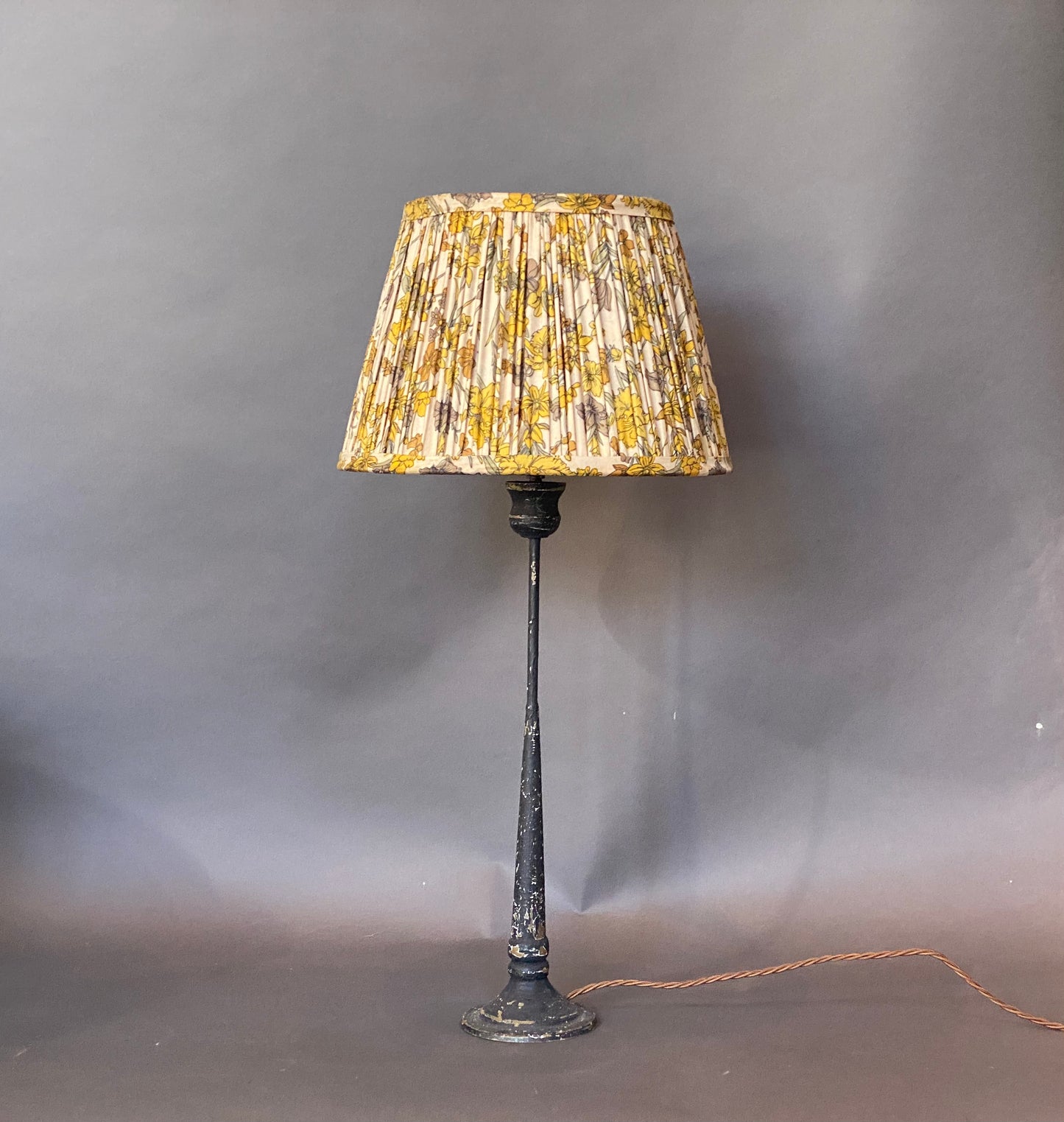 Yellow and grey floral silk Lampshade shown on a candlestick lamp base