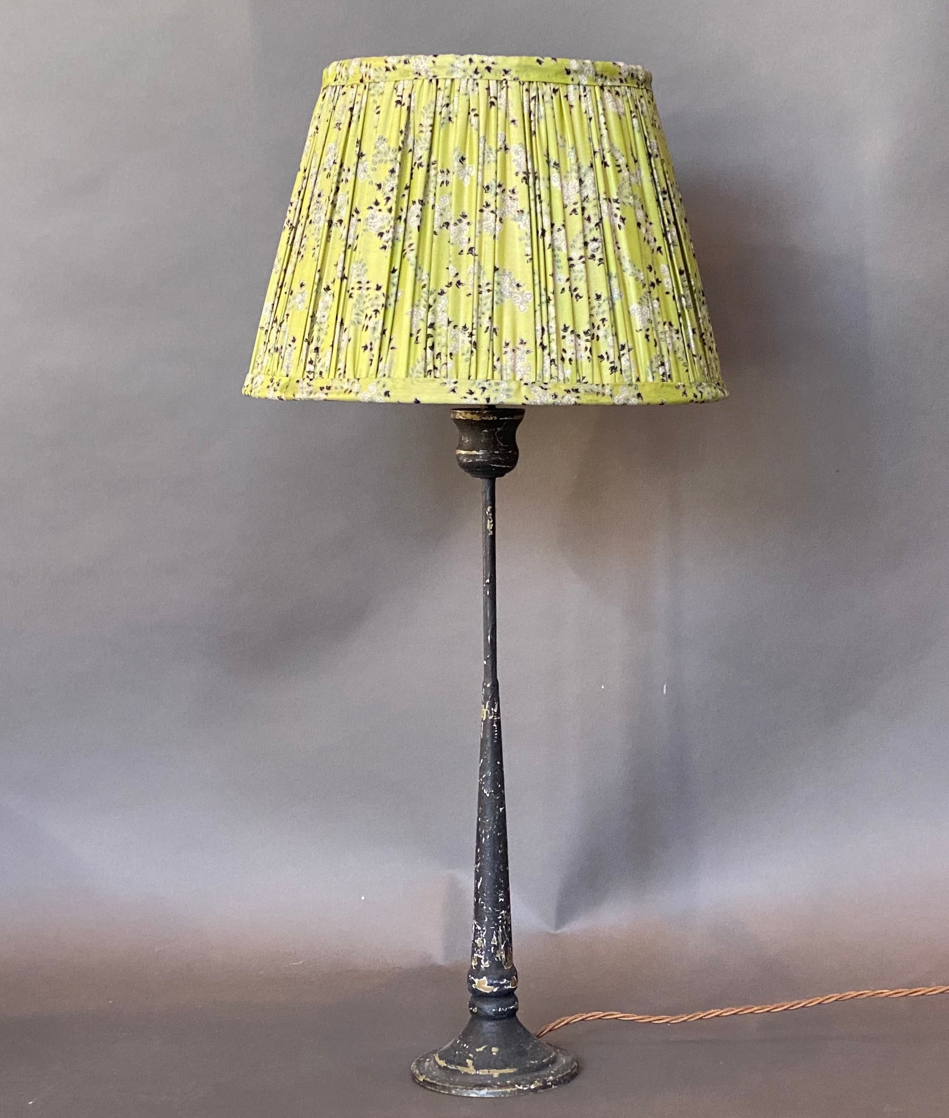 Pistachio paisley silk lampshade shown on a candlestick lamp base