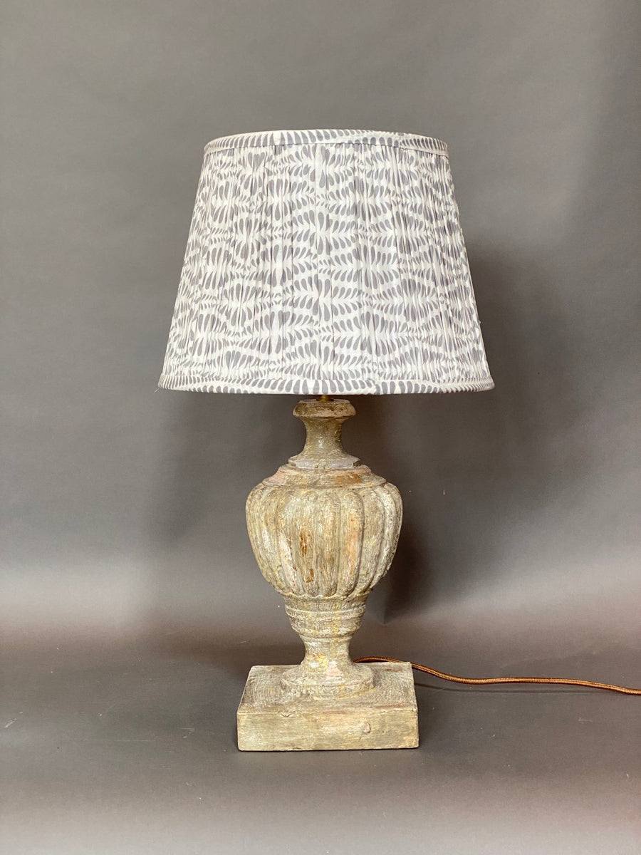 Grey Bangla Cotton Lampshade shown on a medium base shown on a grey background