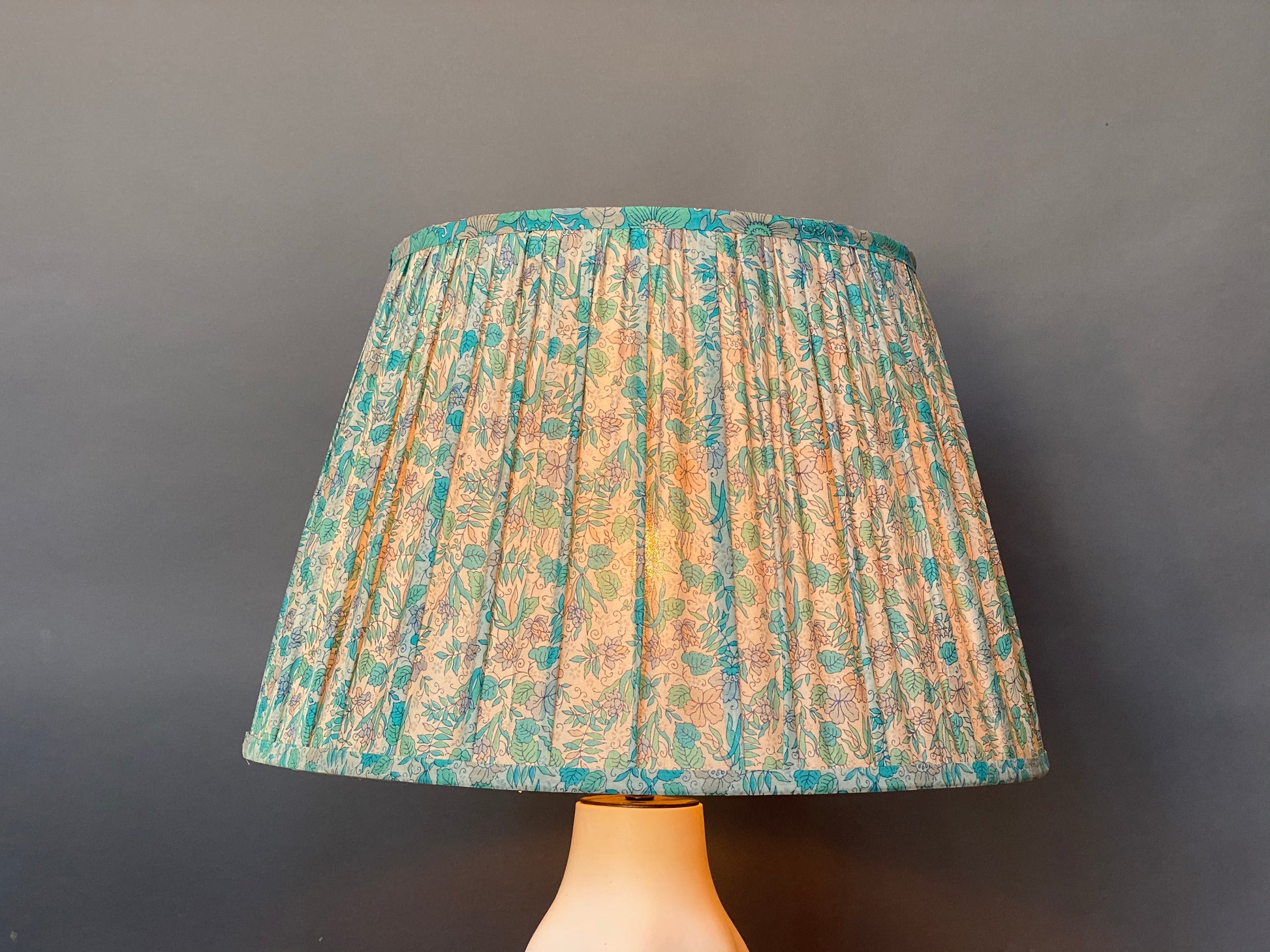 Aqua liberty silk lampshade with light bulb on